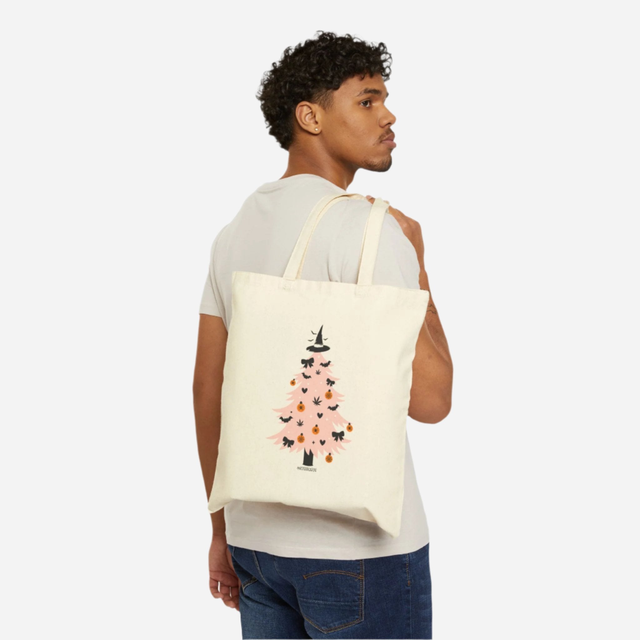 Back of the Witchy Tree Cotton Canvas Tote Bag showcasing a pink Halloween tree decorated with bats, pumpkins, bows, and topped with a witch hat.