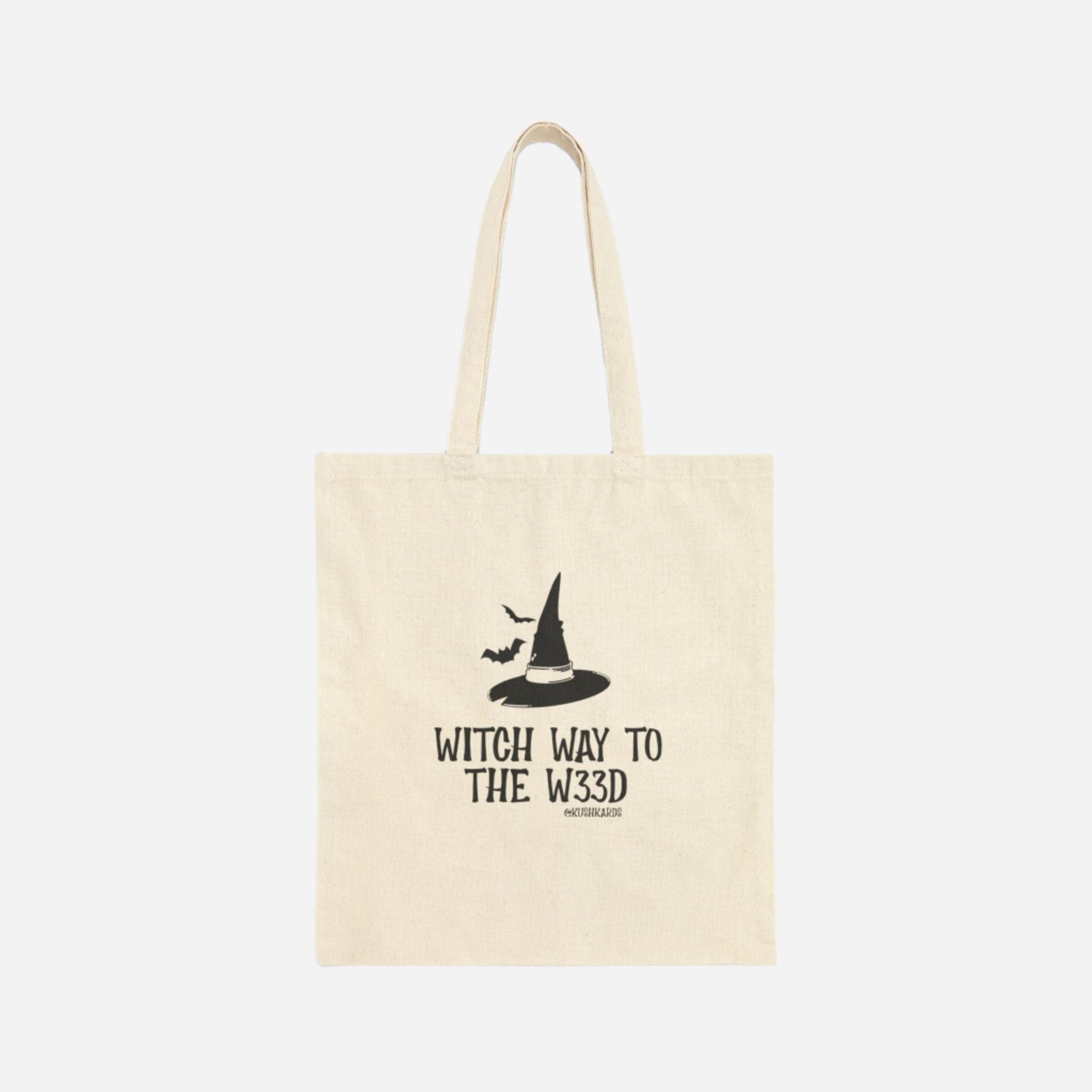 Front of the Witchy Tree Cotton Canvas Tote Bag featuring a black witch hat and bats with the phrase &quot;Witch Way to the W33D.&quot;