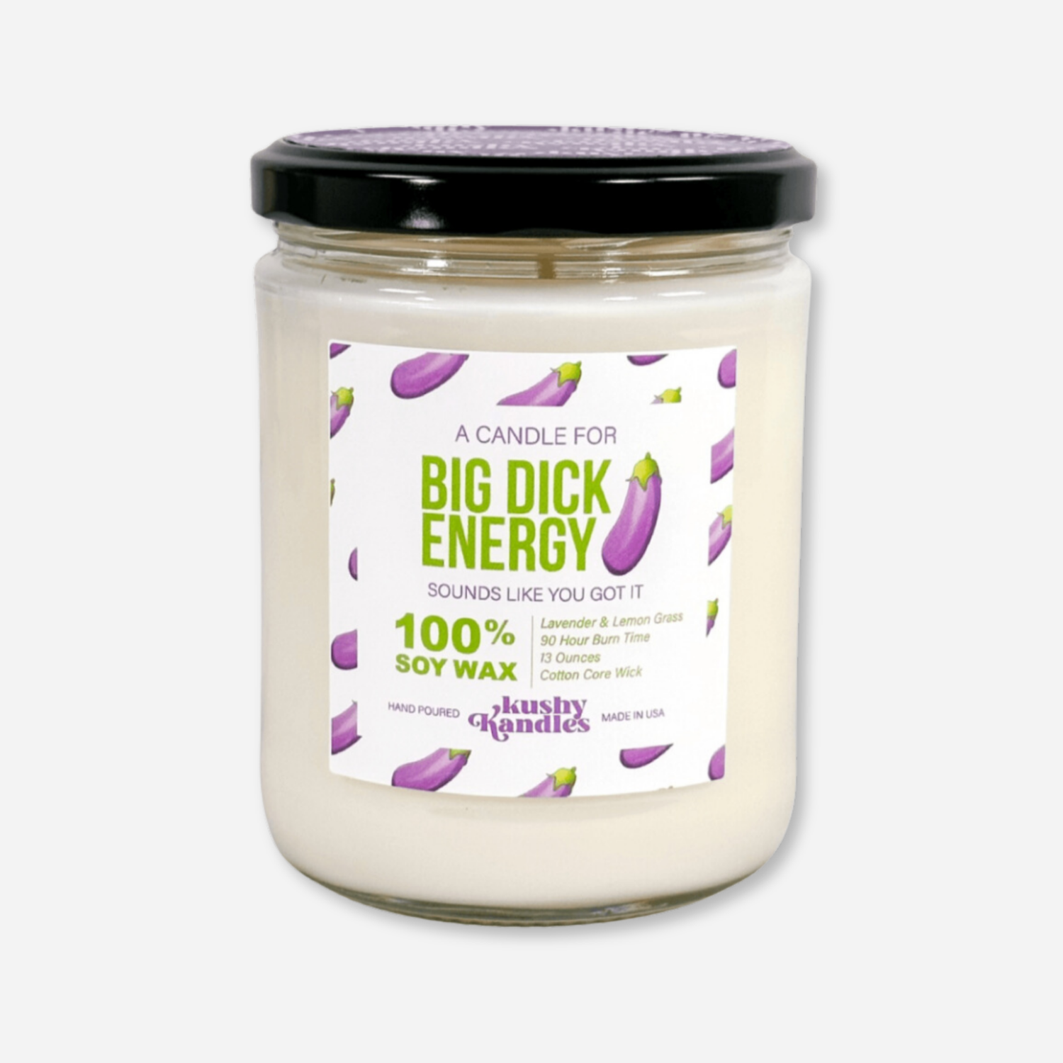 A clean product image of the &quot;Big Dick Energy&quot; soy wax candle in a glass jar with a black lid. The label highlights lavender, lemongrass, and sage scent, a 90-hour burn time, and soy wax ingredients, with playful eggplant emojis decorating the label.