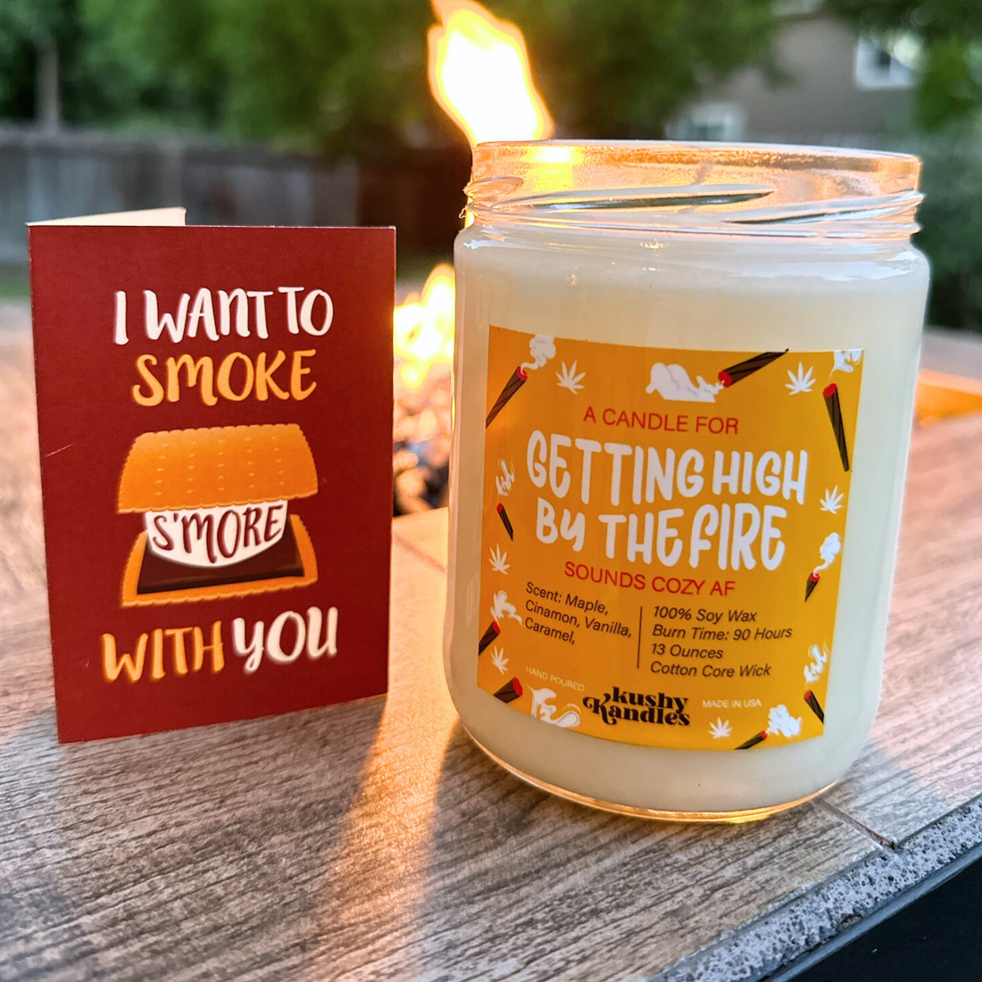 A &quot;Getting High by the Fire&quot; candle displayed next to a card with the text &quot;I Want to Smoke S&