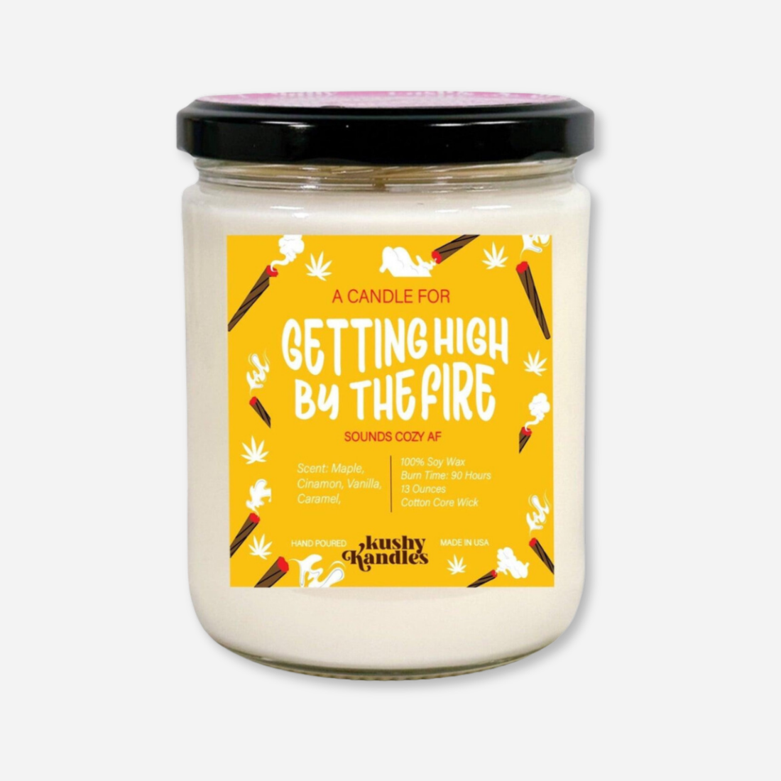 A clean product image of the &quot;Getting High by the Fire&quot; soy wax candle in a glass jar with a black lid. The label highlights its maple, cinnamon, vanilla, and caramel scent with a cozy design. ​