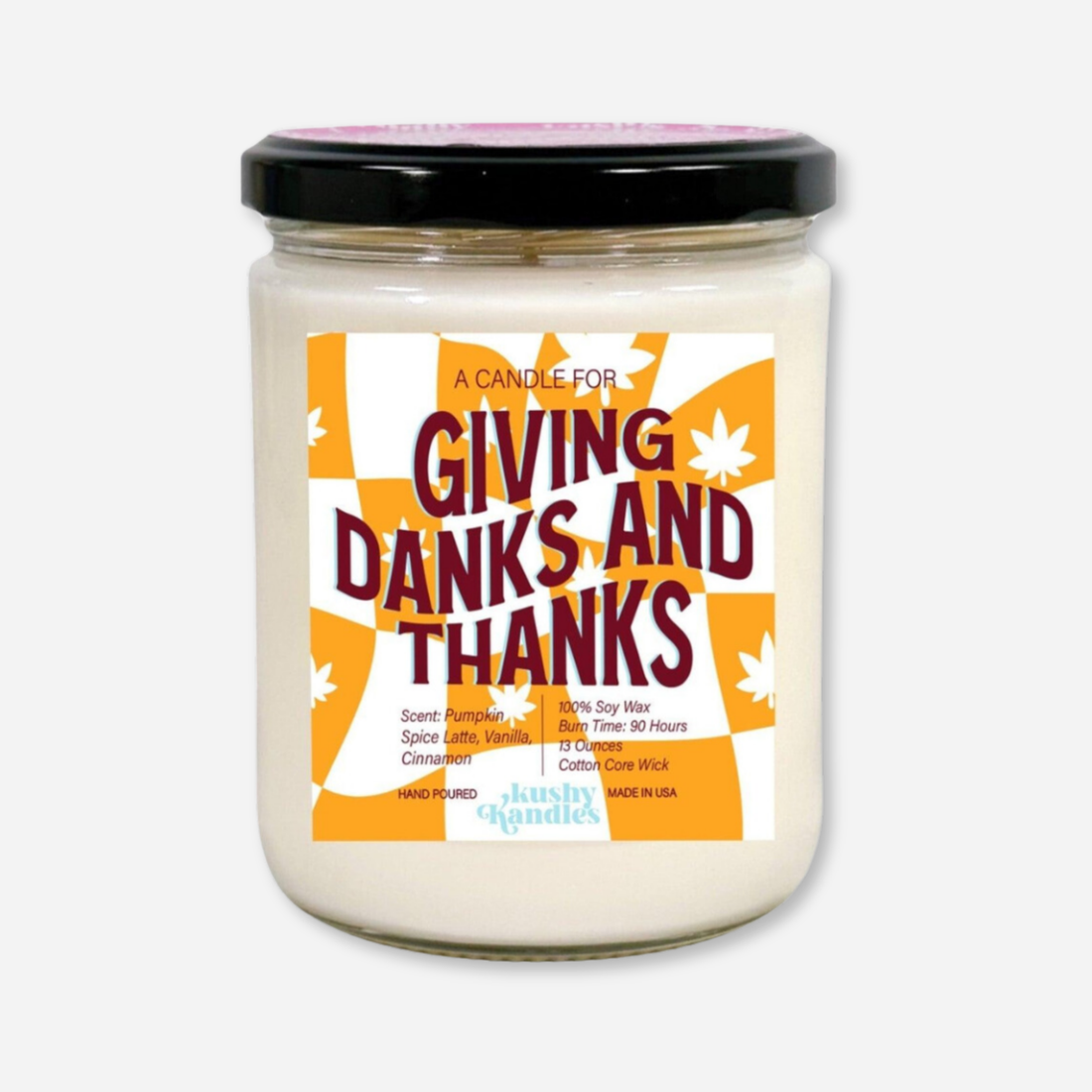 A clean product shot of the Giving Danks &amp; Thanks soy wax candle in a glass jar with a black lid. The label highlights pumpkin spice, vanilla, and cinnamon scent with a 90-hour burn time and 100% soy wax formula.