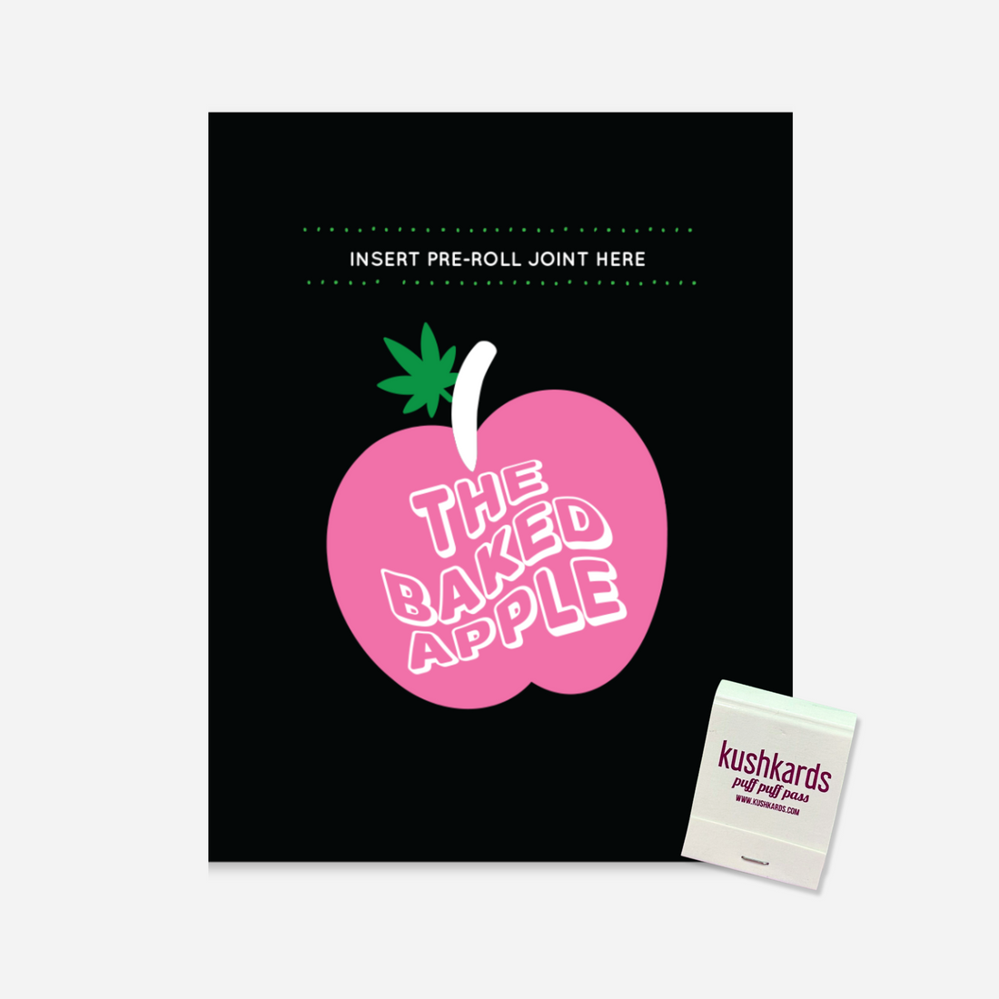 Illustration of a greeting card titled &quot;The Baked Apple&quot; featuring a large pink apple with a green leaf and white stem on a black background. The text &quot;THE BAKED APPLE&quot; is prominently displayed in white and pink letters within the apple. The top border of the card includes a pattern of small pink leaves.