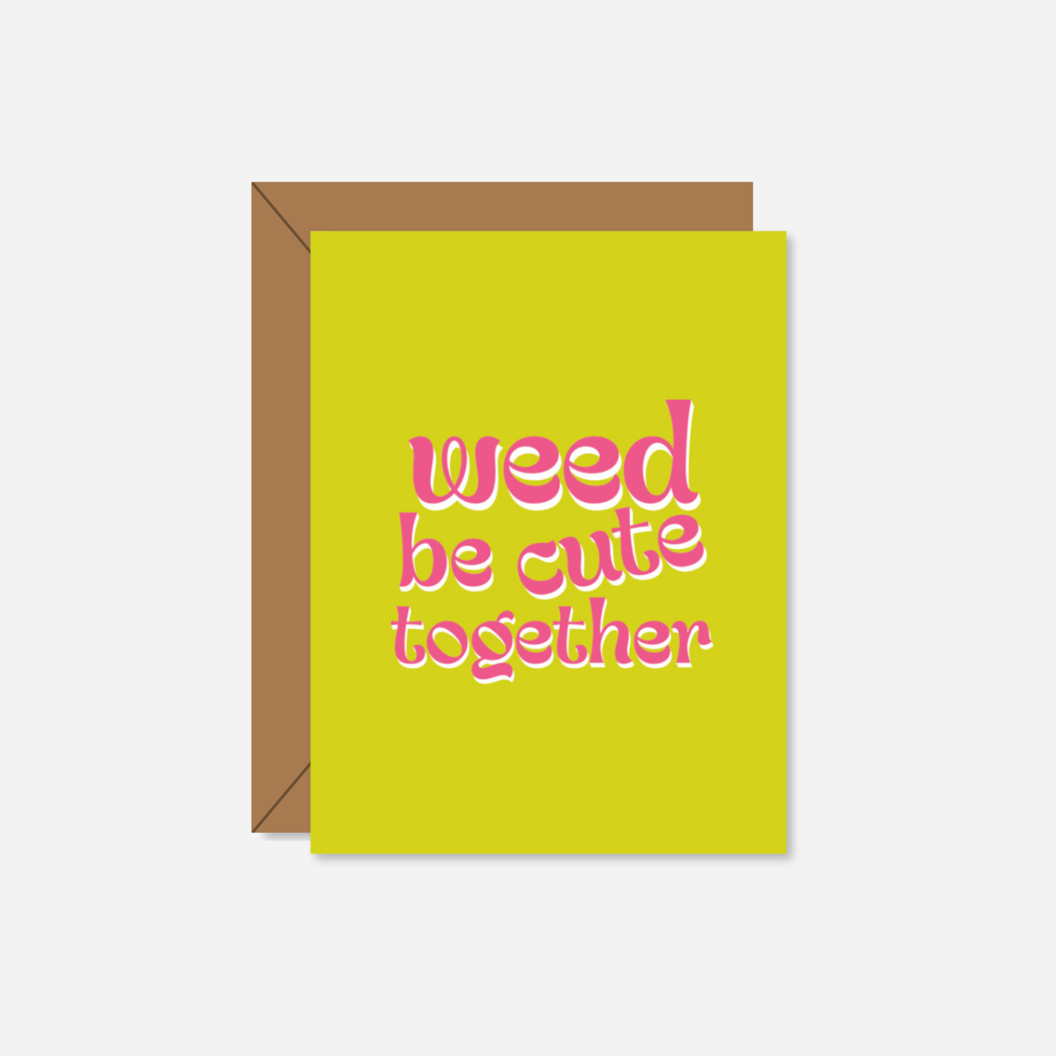 A tiny yellow greeting card featuring the phrase &quot;Weed Be Cute Together&quot; in bold, retro pink and white lettering. The card is paired with a kraft paper envelope.