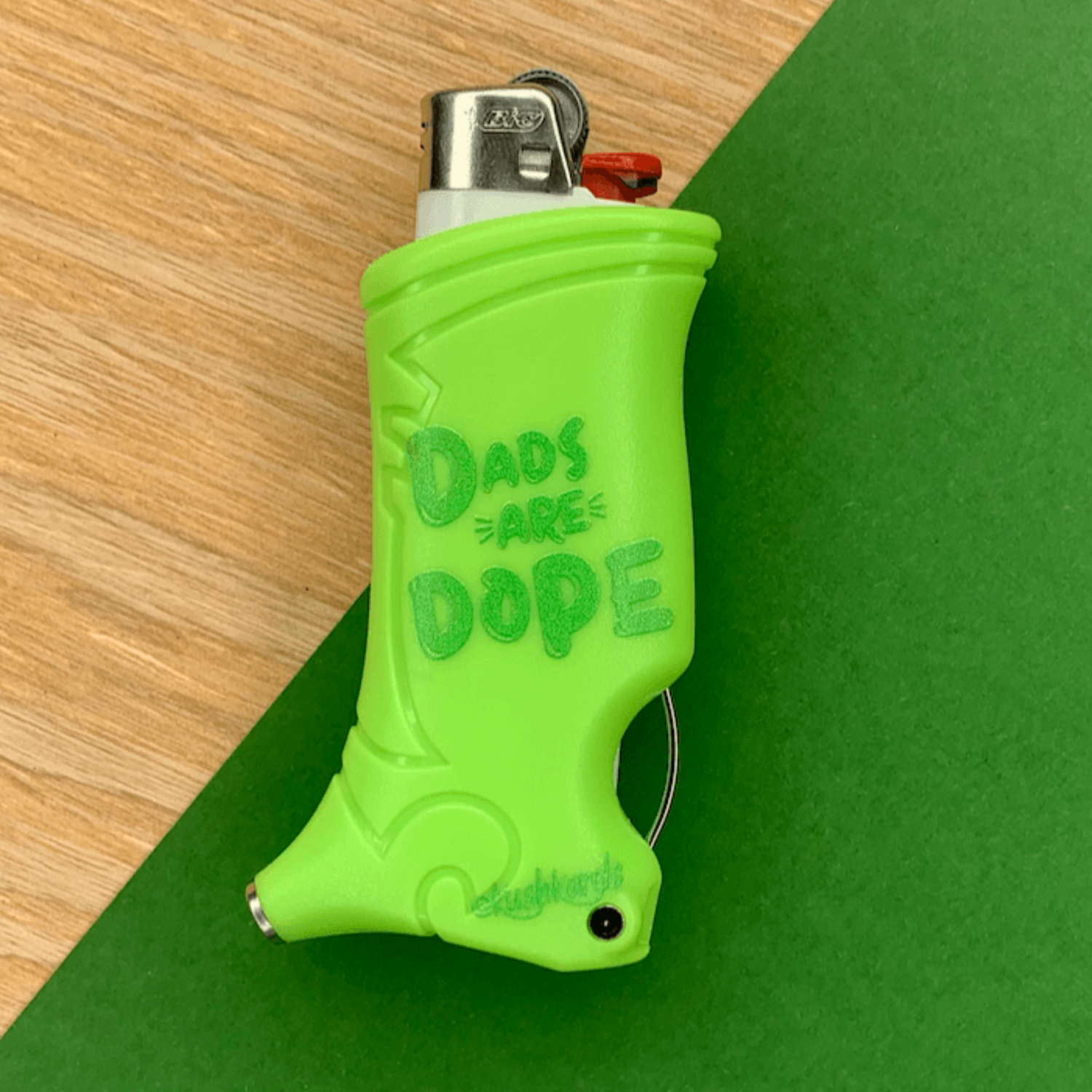 Dope Dad Toker Poker Lighter Case in vibrant green with the message &quot;Dads Are Dope,&quot; featuring a built-in poker and tamper.